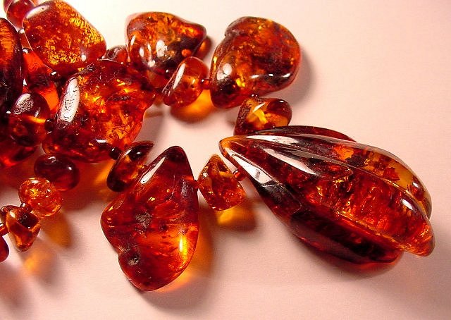 Transparent red amber beads on a light background 