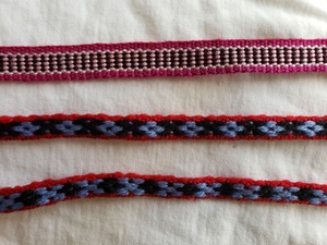 Two handwoven wool ribbons with simple patterns 