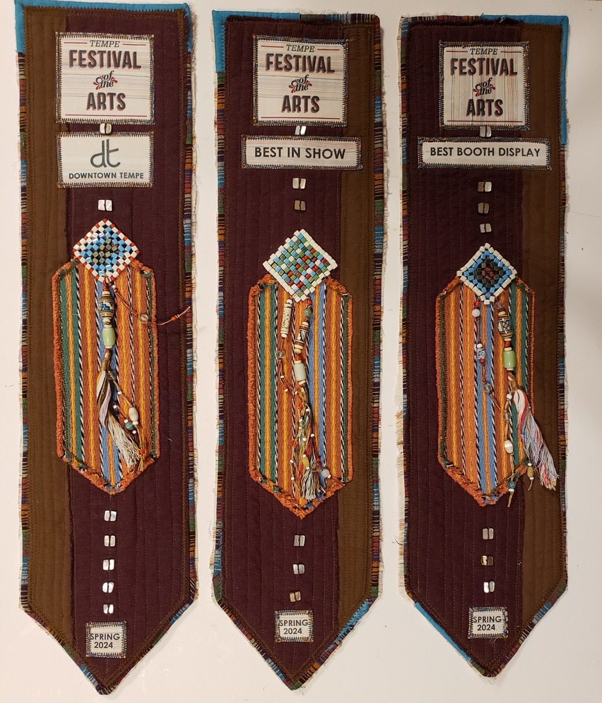 The large 5x20 inch ribbons: Tempe Festival gallery ribbon, Best Booth Display, and Best In Show. 